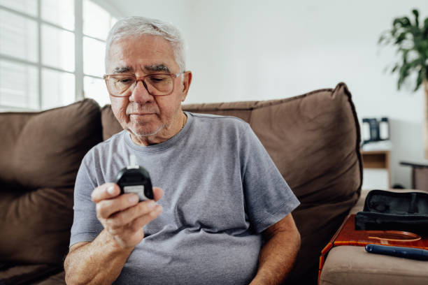 istock Man checking instantaneous blood sugar measurement 1606162834