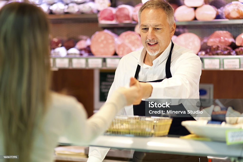Shopping at the supermarket Woman shopping at the supermarket Butcher's Shop Stock Photo