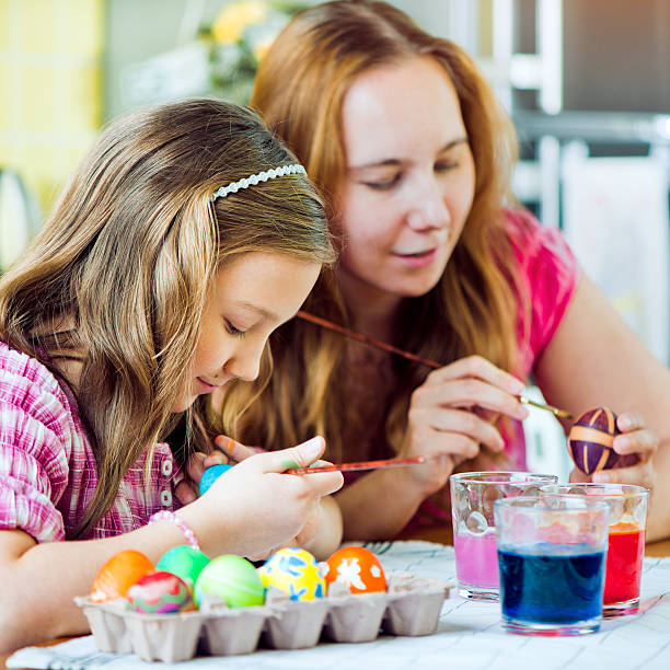 istock Mother and daughter coloring Easter eggs 160618124