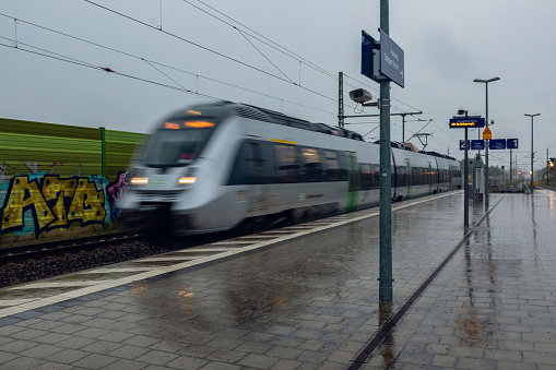 Germany, Saxony, District of Leipzig, Markkleeberg - August 6, 2023: Photo of train S-bahn in Germany. Deutsche Bahn AG photography. Rainy weather. Großstädteln station. Blurred motion, high speed.