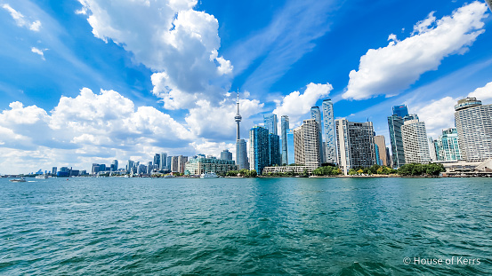 Skyline of  the city of Toronto, ON Canada from vantage point of the water - Lake Ontario | Shown in photo - CN Tower, Harbourfront, Rogers Centre, Financial District | Summer