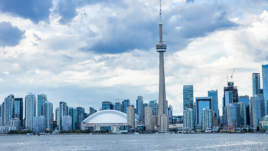 Skyline of  the city of Toronto, ON Canada from vantage point of the water - Lake Ontario | Shown in photo - CN Tower, Harbourfront, Rogers Centre, Financial District | Summer