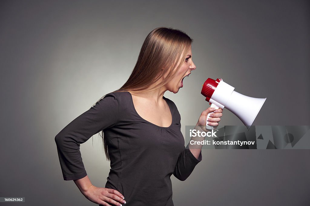 woman shouting in loudspeaker emotional young woman shouting in loudspeaker 20-29 Years Stock Photo