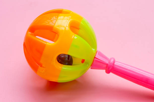 istock Colorful baby rattle on pink background. Copy space 1606307926