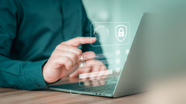 istock Young man login with fingerprint scanning technology in the computer laptop. Secure encryption and access to the user's private information to access the internet. 1606311385