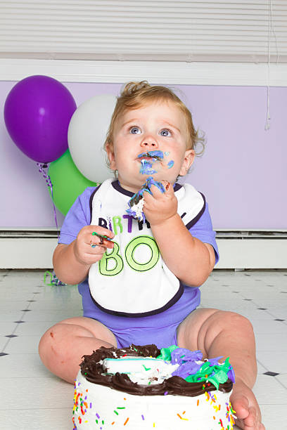 istock baby eating birthday cake 160631317