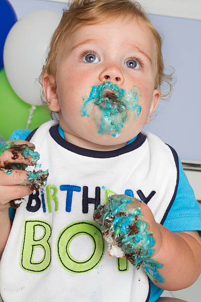 istock baby eating birthday cake 160631323