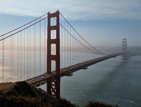 Golden Gate bridge with light morning fog on cityscape