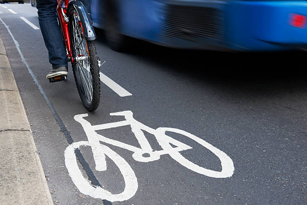istock Man On Bike Using Cycle Lane As Traffic Speeds Past 160632238
