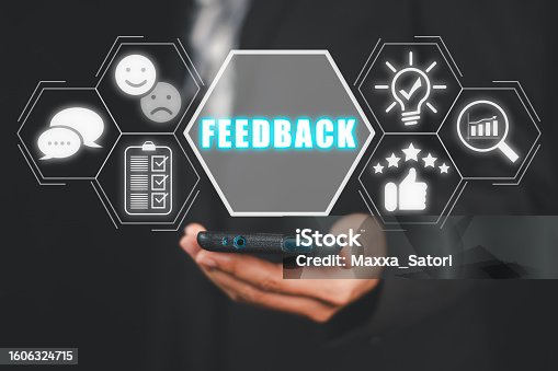 istock Feedback concept, Business person hand holding smartphone with feedback icon on virtual screen. 1606324715