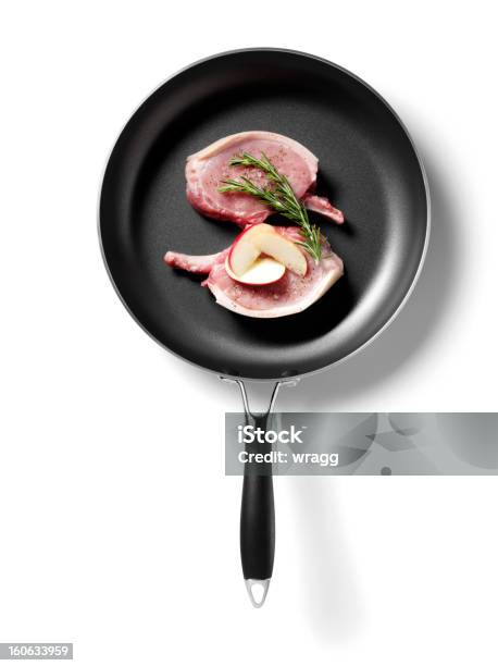 Isolated Uncooked Pork Chop In A Frying Pan Stock Photo - Download Image Now - Frying Pan, White Background, Apple - Fruit