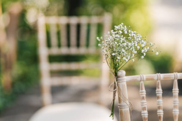Chair with a fresh plant wedding decoration. Wedding reception.
