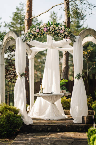 istock Beautiful wedding arch decorated with fresh flowers 1606345874