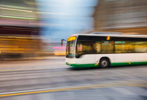 Bus driving on city street, motion blur, panning