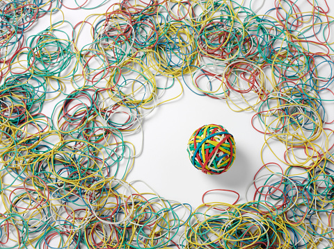 Rubber ball surrounded by elastic bands 