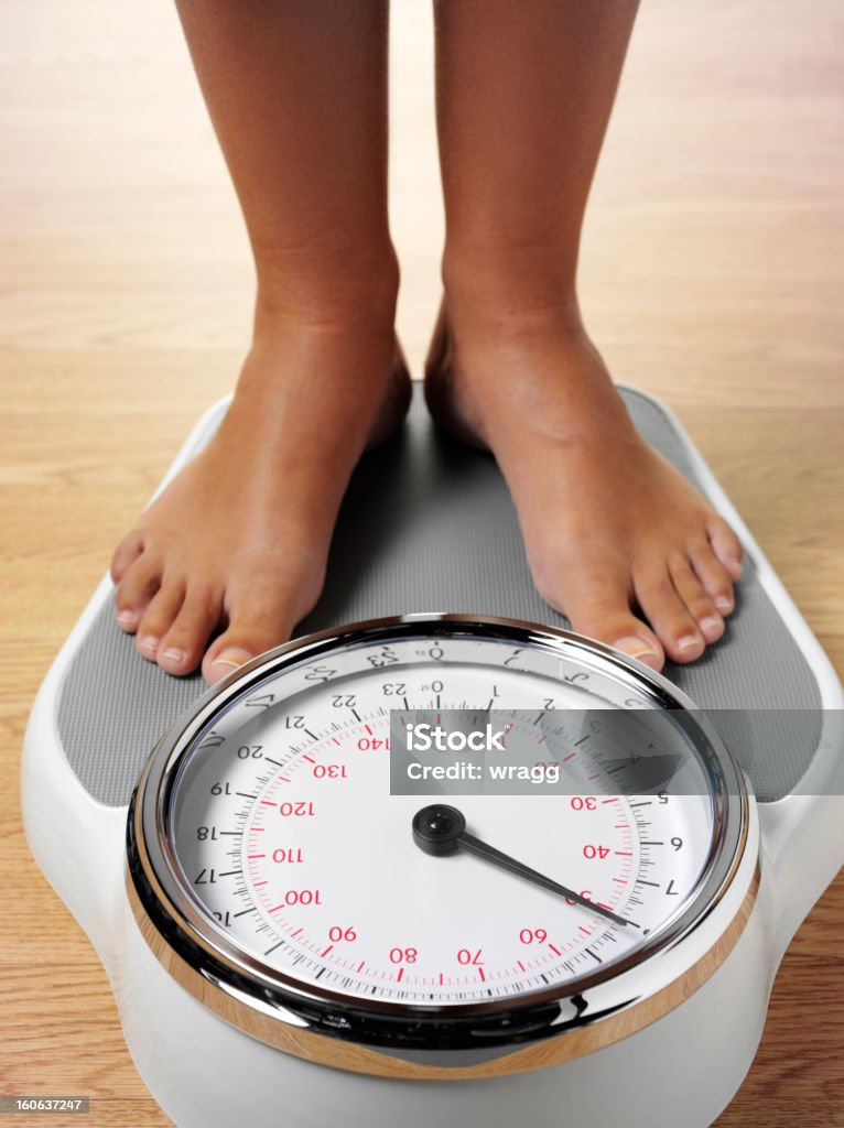 Standing On Weighing Scales Stock Photo - Download Image Now