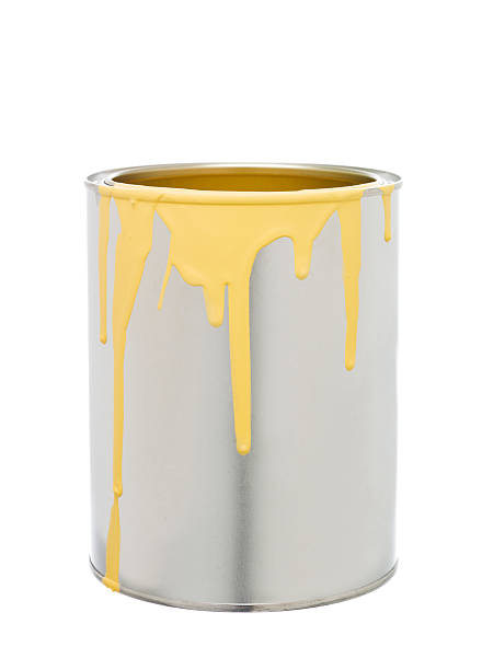 Paint Can with Yellow spill stock photo