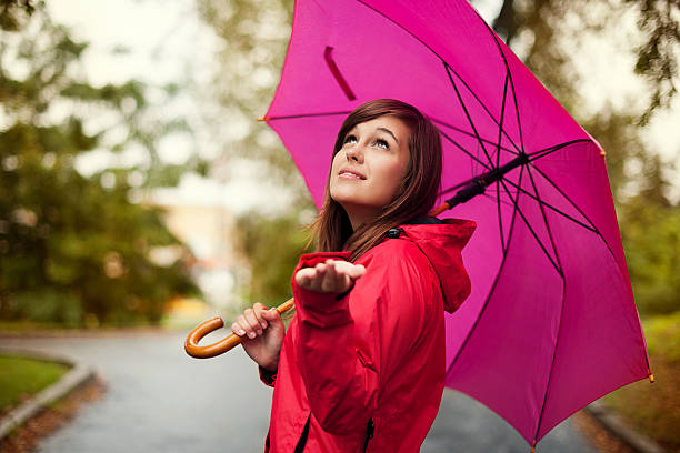 istock Beautiful woman with umbrella checking for rain 160639782