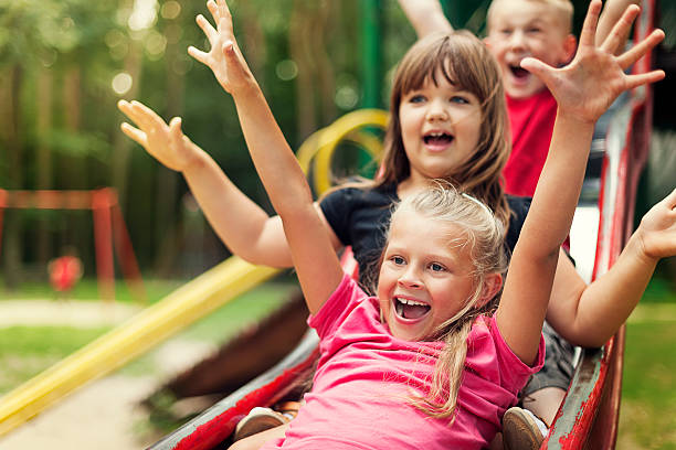 Happy kids playing on slide Happy kids playing on slide 9 stock pictures, royalty-free photos & images