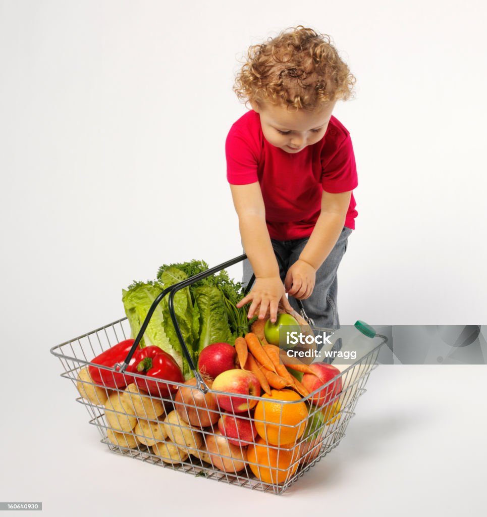 Bambino piccolo con frutta e verdura in un cestino - Foto stock royalty-free di Bambino