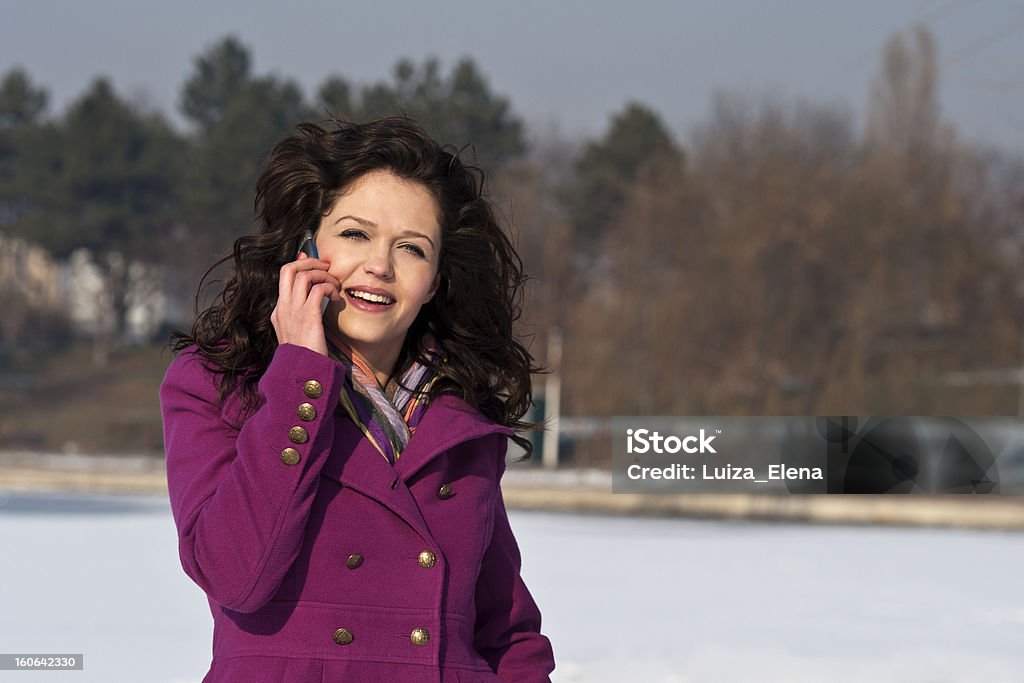 Young beautiful smiling woman talking on cell phone A portrait of a smiling beautiful woman talking on the phone 20-29 Years Stock Photo