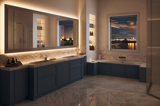 3D rendered interior of a contemporary white / blue bathroom with washstand and bathtube at night.