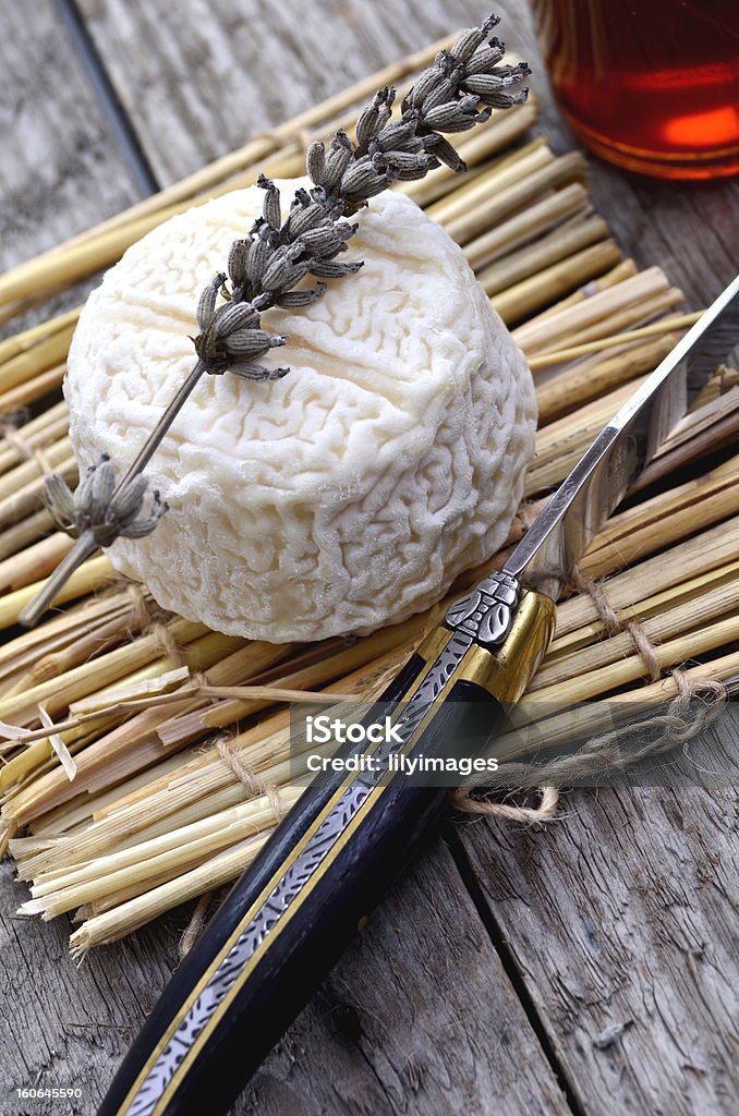 Goats cheese with lavender and honey pot French goats cheese on a straw mat with lavender and honey pot. Antipasto Stock Photo