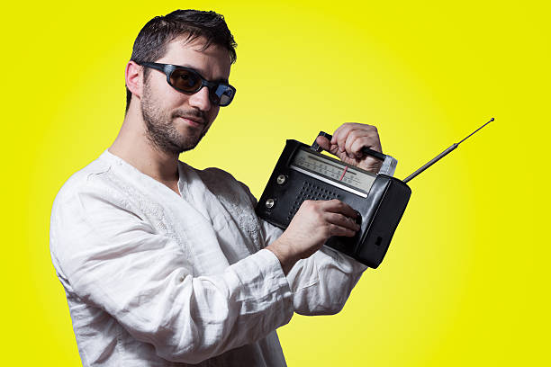 istock Young bearded man holding a vintage radio 160646980