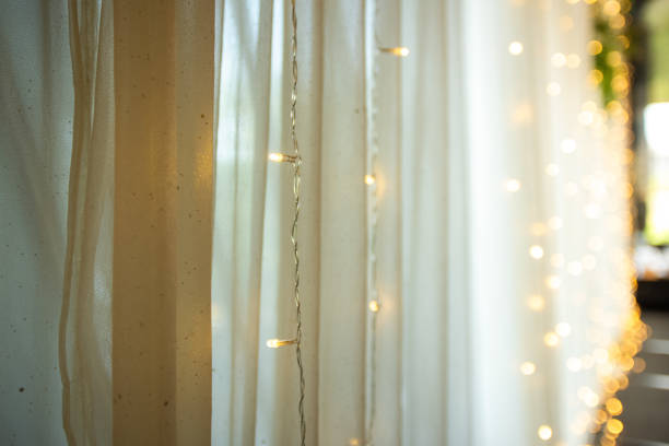 istock Blurred image of decorative string lights with transparent gauze background 1606483441