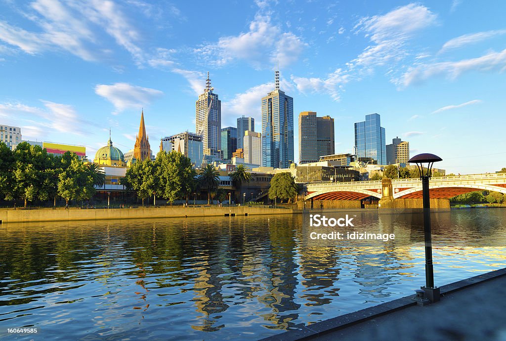 A skyline image of Melbourne with bright blue sky The skyline of Melbourne and the Princess Bridge,  Photographed from Southbank Promenade along the Yarra River. Melbourne - Australia Stock Photo