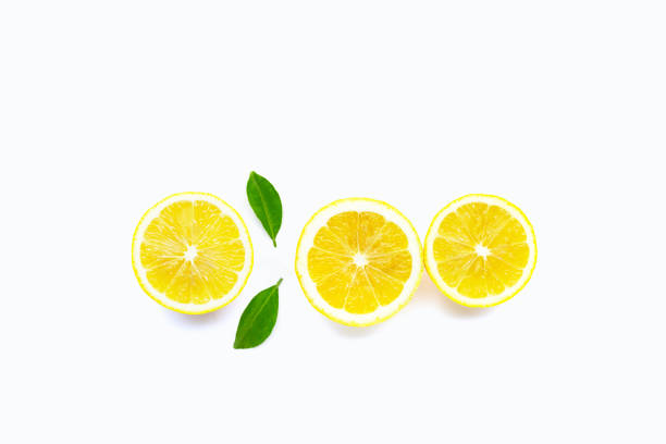 istock Fresh lemon with green leaves on white. Copy space for text or product 1606537012