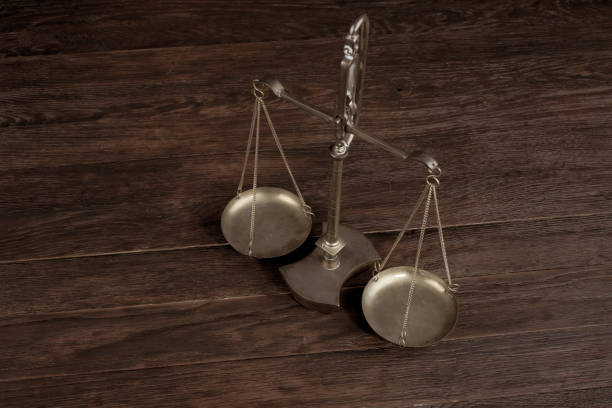 istock Bronze traditional balance scale on wooden table 1606547230
