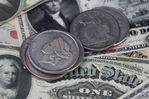 istock Old west US banknotes and silver certificates with silver dollar coins 1606547568