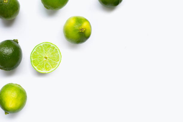 istock Fresh limes with leaves isolated on white 1606565817