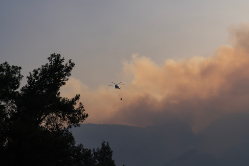 Firefighter Helicopter fighting against Forest Fire in Kemer, Antalya, Turkiye.  Kemer is one of the most popular tourist destinations on the west coast of Antalya.