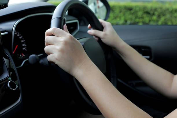 istock Hands holding steering wheel of car 1606613626