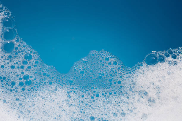 istock Detergent foam bubble on water. Blue background, Soap sud 1606644626