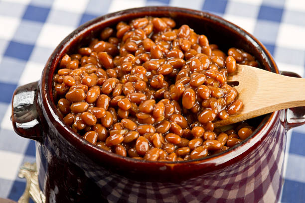 Pot of Baked Beans on a Blue Gingham Pot of Baked Beans on a Blue Gingham baked beans stock pictures, royalty-free photos & images