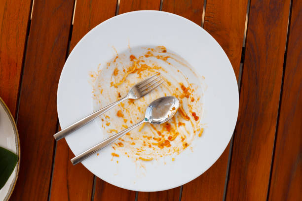 istock Dirty dish on wooden background. 1606665296