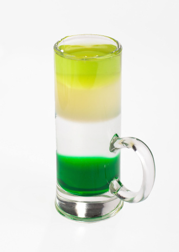 Green Mехican shot cocktail on isolated white background