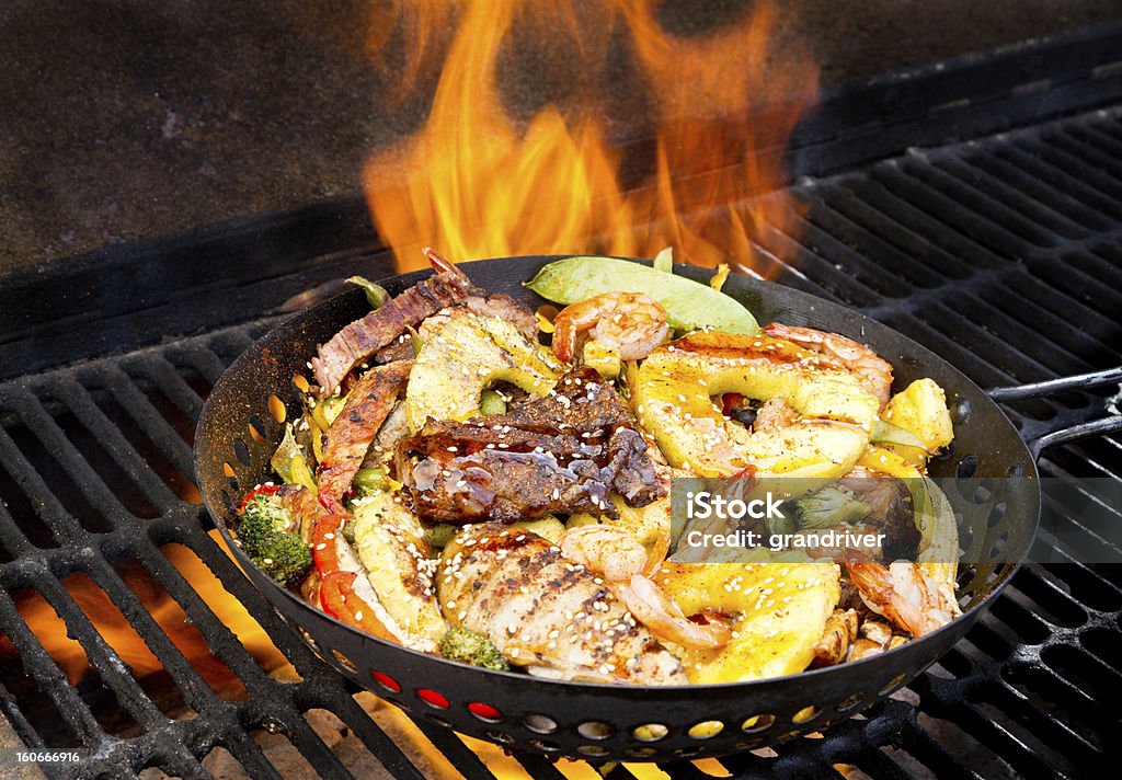 Stir Fry on Barbecue Grill Stir Fry on Barbecue Grill with shrimp, beef, chicken, vegetables, pineapple, bell peppers, snow peas Pineapple Stock Photo