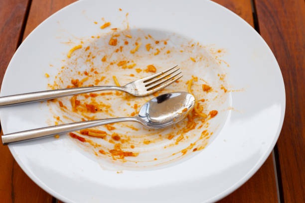 istock Dirty dish on wooden background. 1606718125
