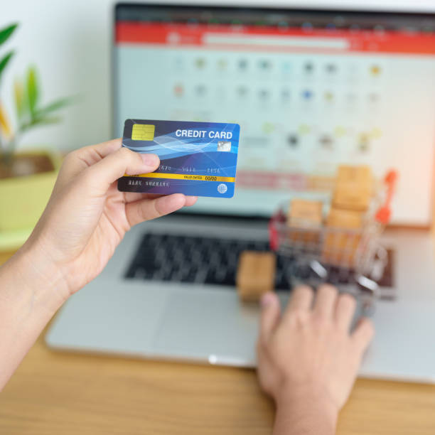 woman hand holding credit card and using laptop with mobile phone for online shopping while making order. Marketplace platform website, technology, ecommerce, shipping delivery and online payment mujer sosteniendo la tarjeta de crédito y usando una computadora portátil con un teléfono móvil para compras en línea mientras hace el pedido. sitio web de la plataforma de mercado, tecnología, comercio electrónico, entrega de envíos y pago en lín