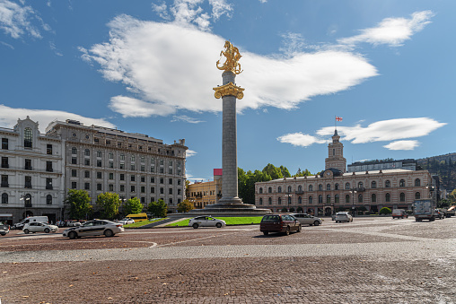 Monument of Russian emperor Peter the Great, known as The Bronze Horseman in St. Petersburg, Russia (1782). Blue clear sky and green trees background