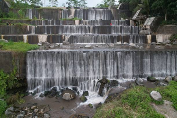 istock waterfall in slow speed photo. soft white waterfall. water flow. cascade flow water in a river. slow motion water. 1606732555