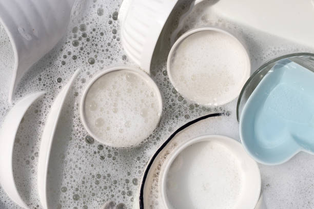 istock Dishes and bowls in water and bubbles of dishwashing liquid. Kitchen work 1606734019
