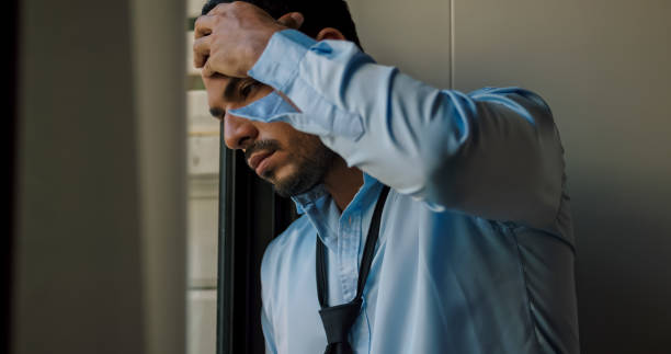 istock A businessman is standing by the window depressed and stressed with problems in his life. 1606757141