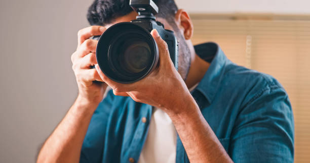 istock Professional male photographer working in studio. 1606757479