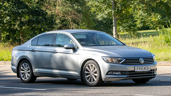 Milton Keynes,UK - Aug 10th 2023: 2015 silver Volkswagen Passat car driving on an English country road.