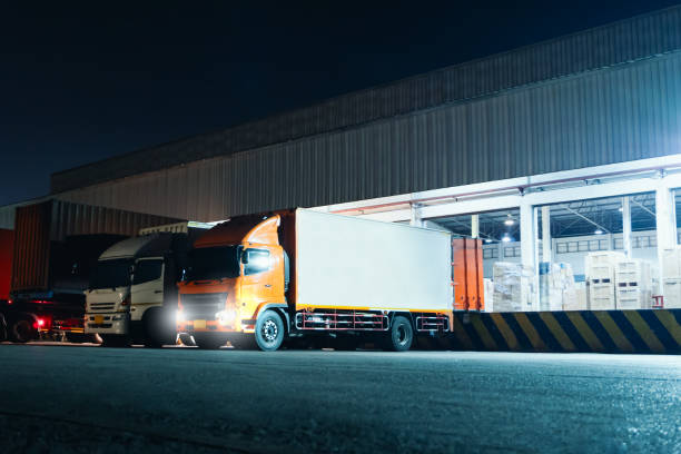 istock Trucks Loading Goods at Warehouse Port at Night. Trucks Loading Dock Warehouse. Supply Chain Warehouse Shipping, Cargo Shipment. Freight Truck Logistic, Cargo Transport. 1606819024